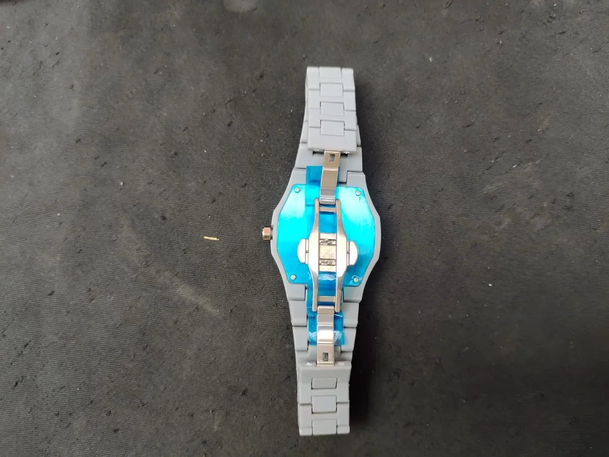 Toy watch made of interlocking bricks on a dark surface