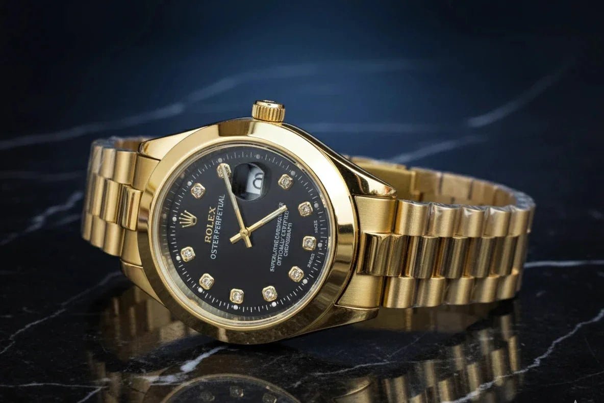 Gold wristwatch with a black dial on a reflective dark surface