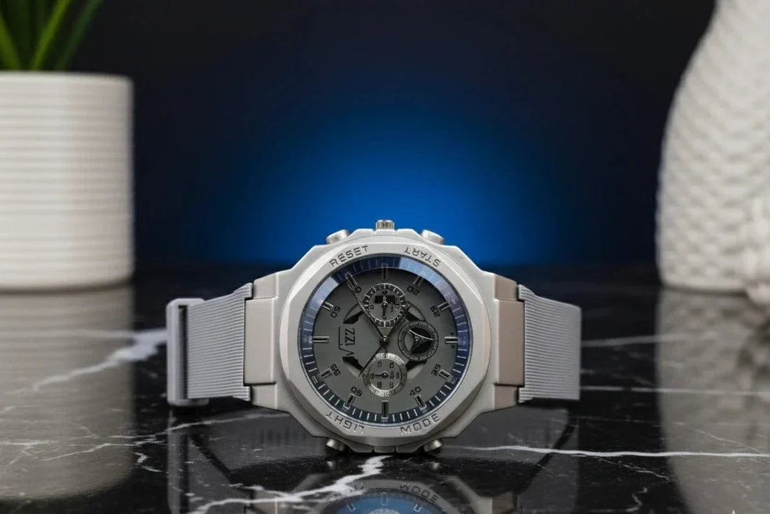 Silver watch with a reflective surface on a dark background
