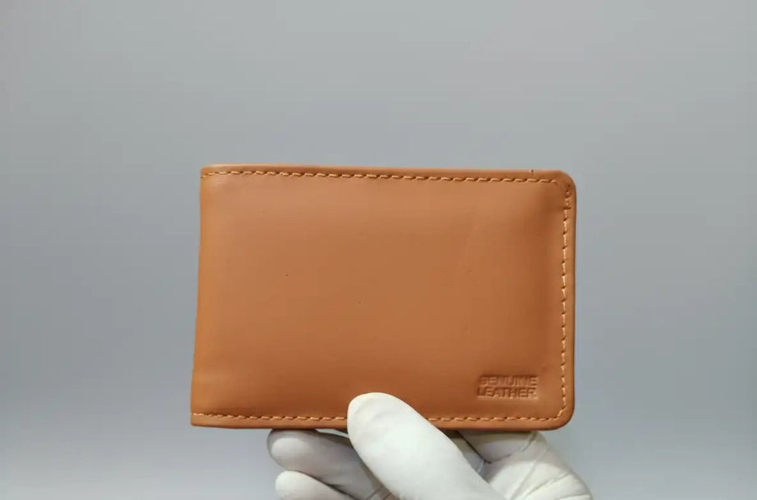 Three leather wallets in gray, brown, and black on a light gray background