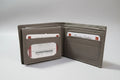 Open brown leather wallet with card slots on a gray background