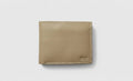 Beige leather wallet on a light gray background