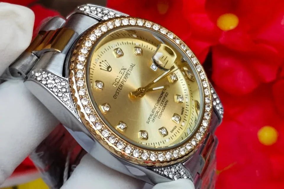 Luxury watch with gold face and silver case against a red floral background