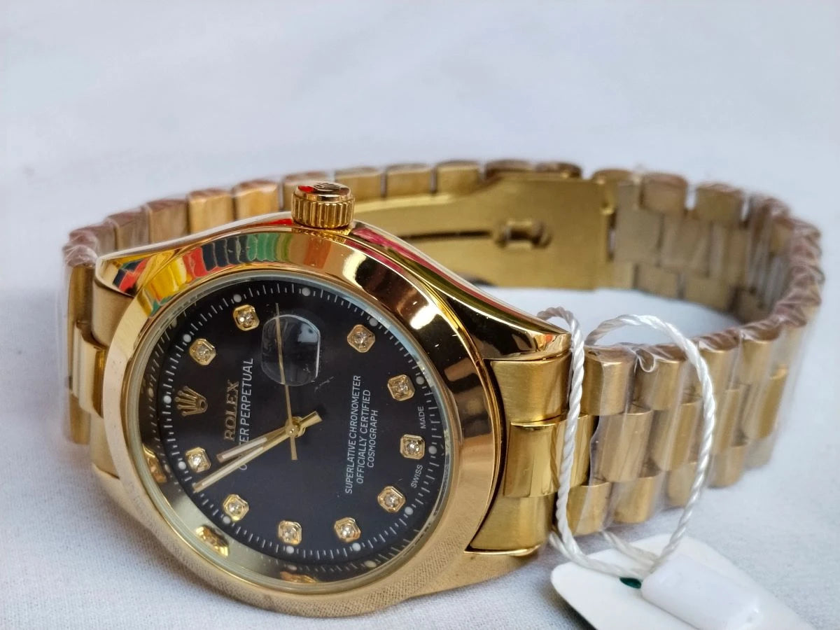 Gold wristwatch with a black face on a white background