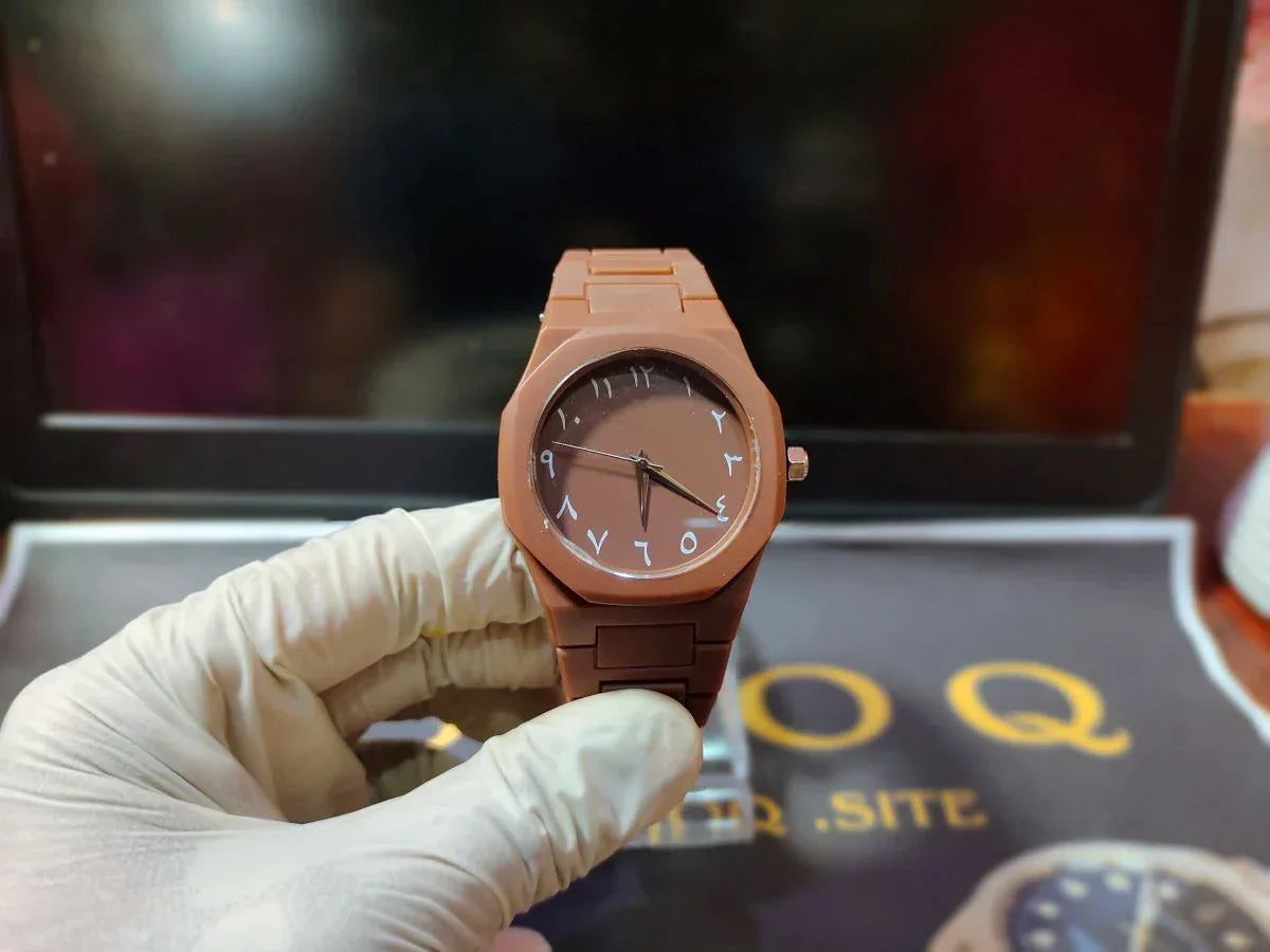 Brown wooden watch held by a gloved hand with a blurred background