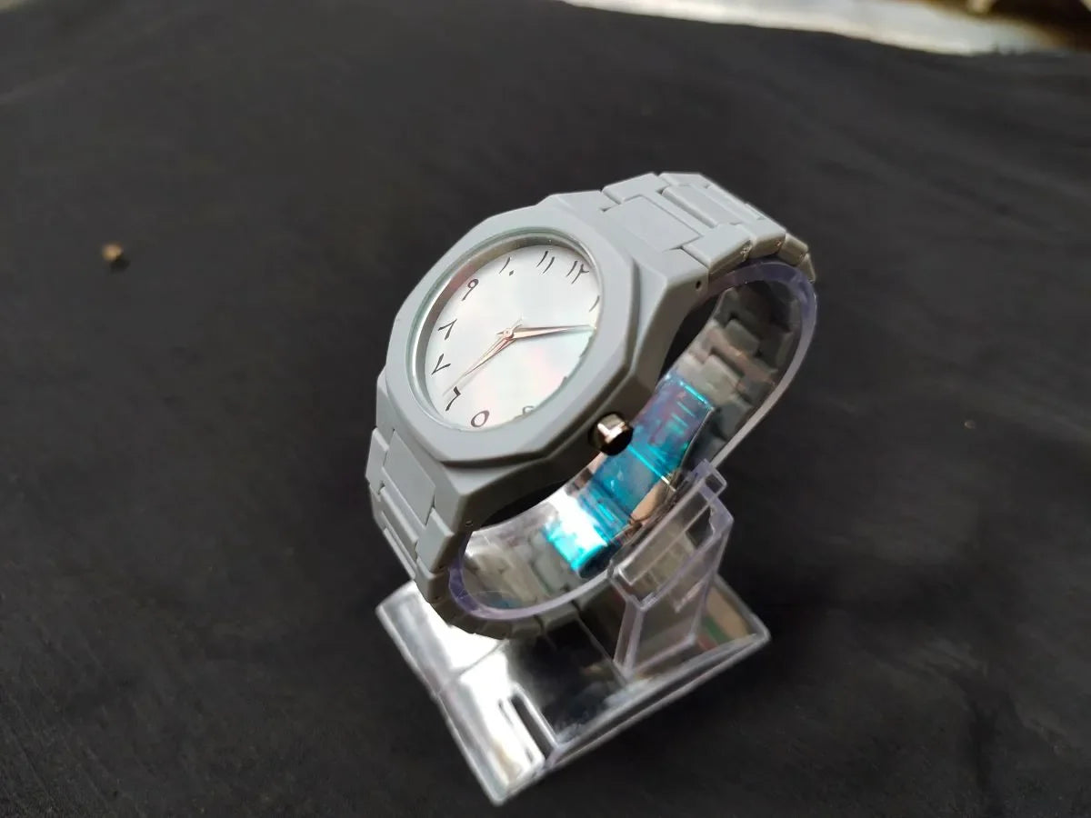 Gray watch with a unique design on a dark surface