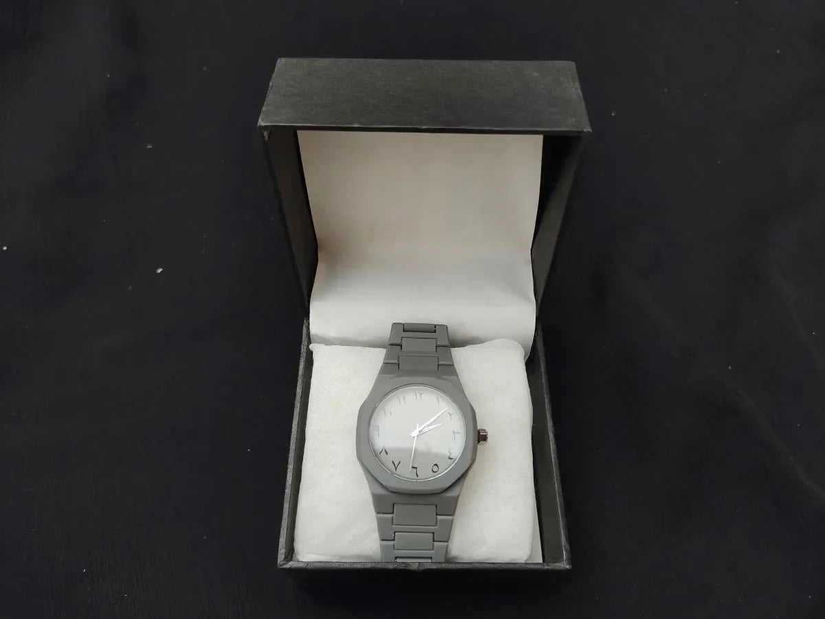 Gray wristwatch in a box on a black background