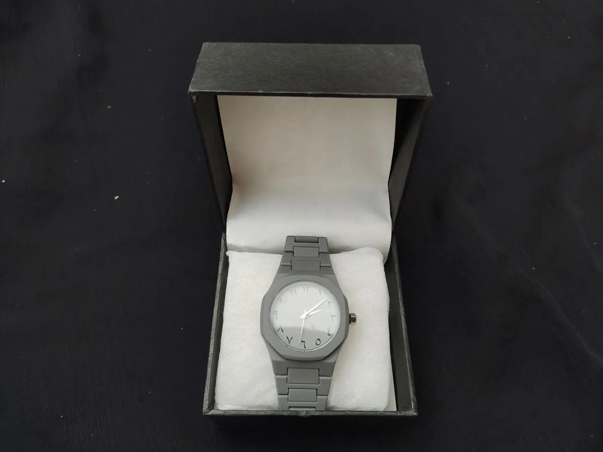 Gray wristwatch in a box on a black background
