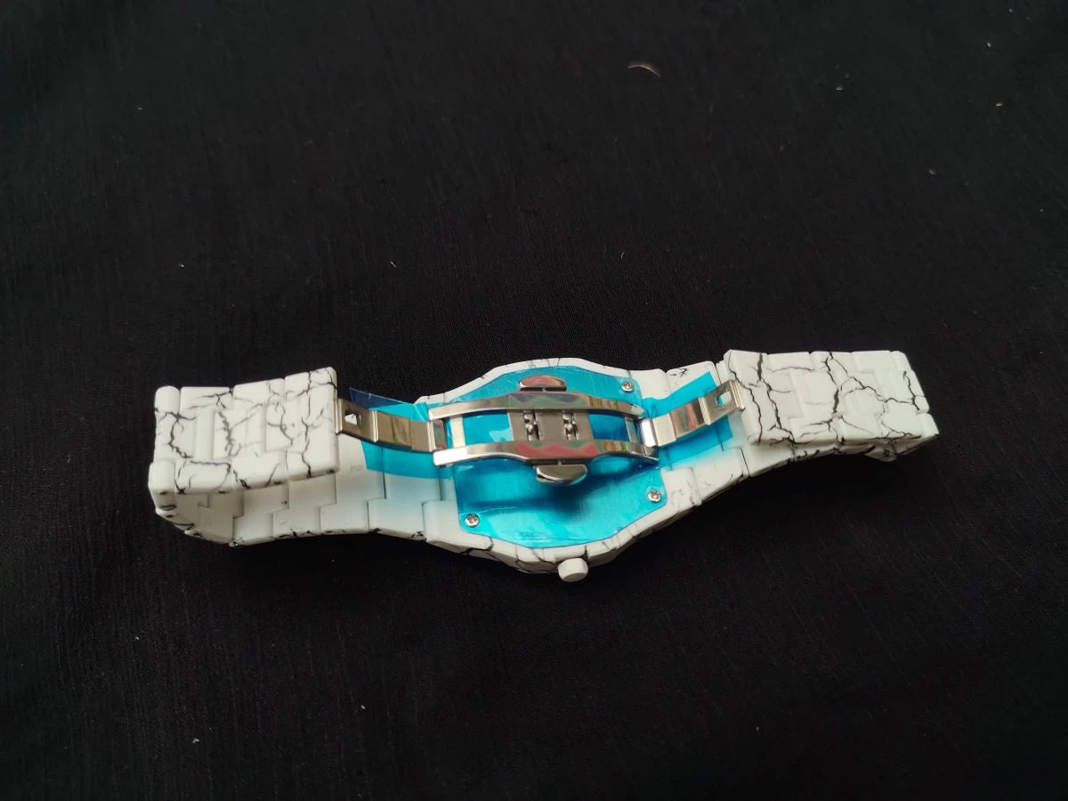 Decorative belt with blue center and silver accents on a black background