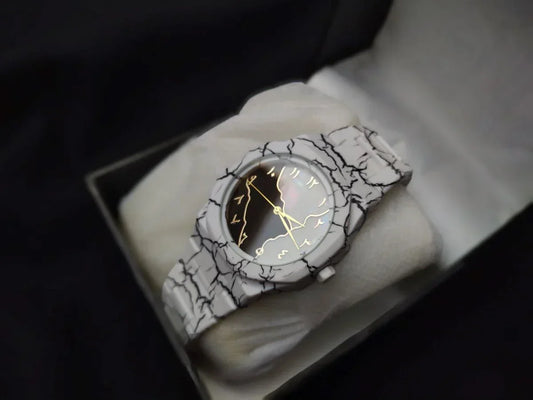 Wristwatch with a cracked design on a white surface