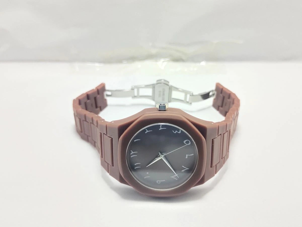 Watch with a brown strap and black face on a white background
