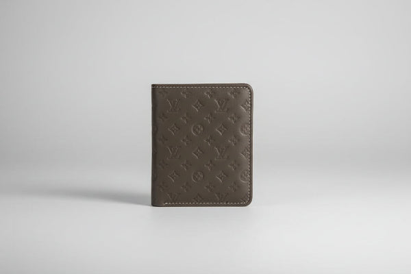 Louis Vuitton wallet with monogram pattern on a marble surface