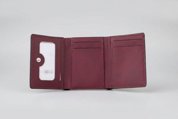 Maroon leather wallet on a white background