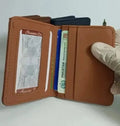 Brown leather wallet with cards and documents on a white background