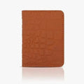 Brown leather cardholder with crocodile texture on a white background