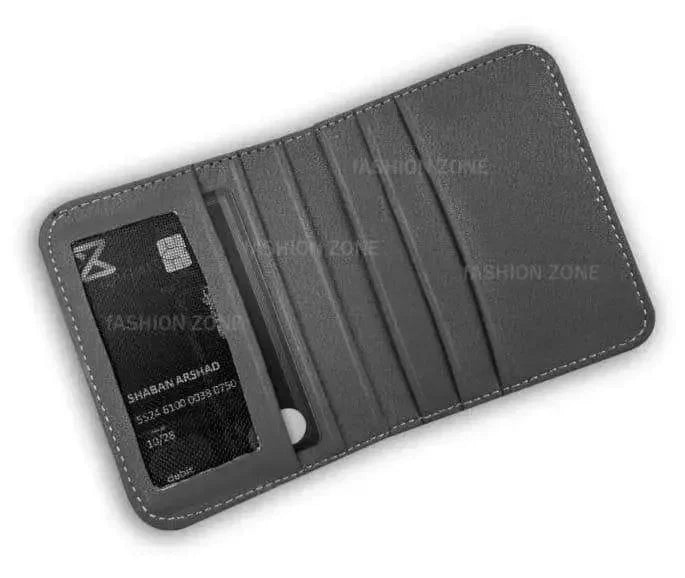 Gray Puma wallet held in a hand against a beige background