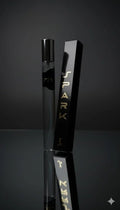Black vape device with 'Spark' branding on a reflective surface against a dark background