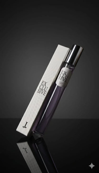 Perfume bottle labeled 'Exclusive' with packaging on a reflective surface