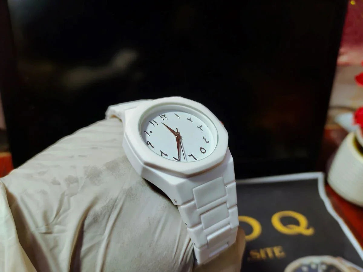 White watch on a wrist with a blurred background